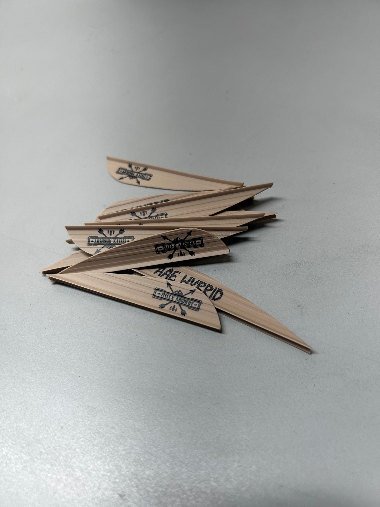 Set of wooden arrows with "HAE HERRID" printed in black on light wood.