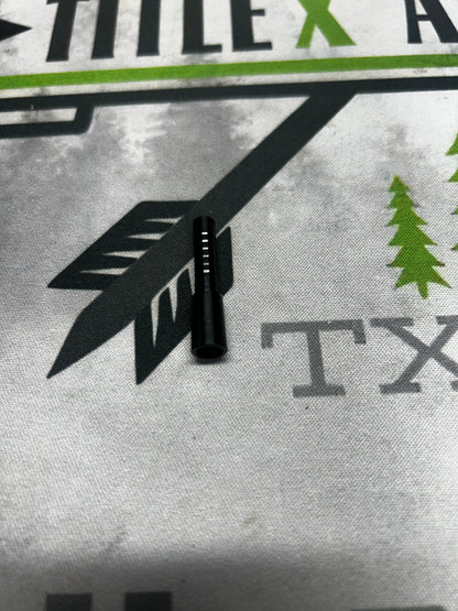 Black aluminum half-out arrow tip, shown on a white fabric background with graphic designs.