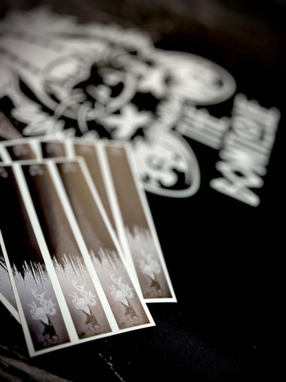 Set of brown and black patterned arrow wraps, featuring subtle white graphic designs, laid on a dark surface.