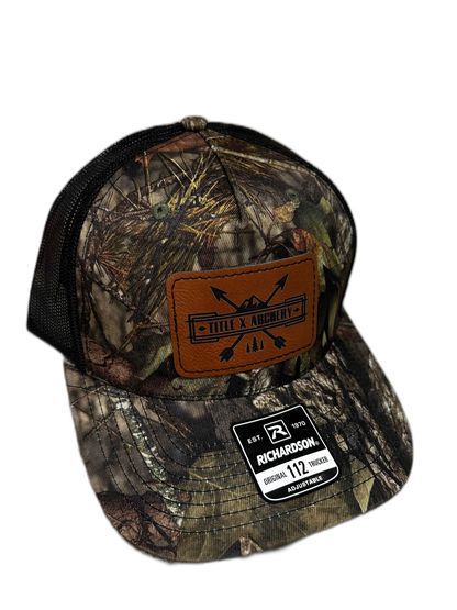 Camo baseball cap featuring Title X Archery and Richardson 112 patches. | titlex-cutout