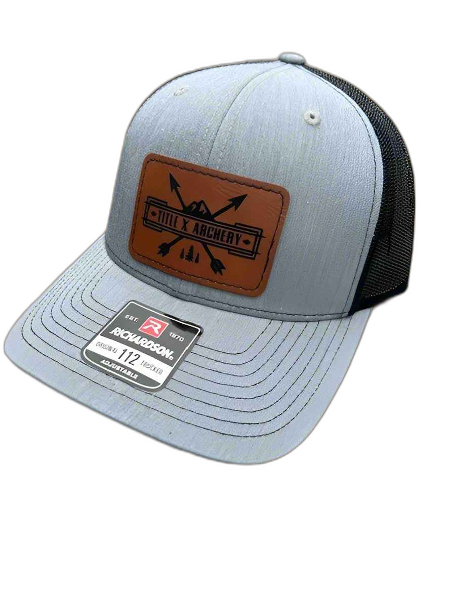 Gray and black Richardson 112 trucker hat with a brown TitleX Archery patch. | titlex-cutout